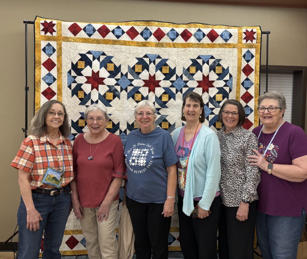 A quilt with a pattern of stars and squares.
